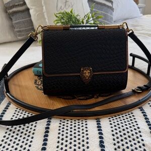 Chic Black Crossbody Bag with Lion Emblem